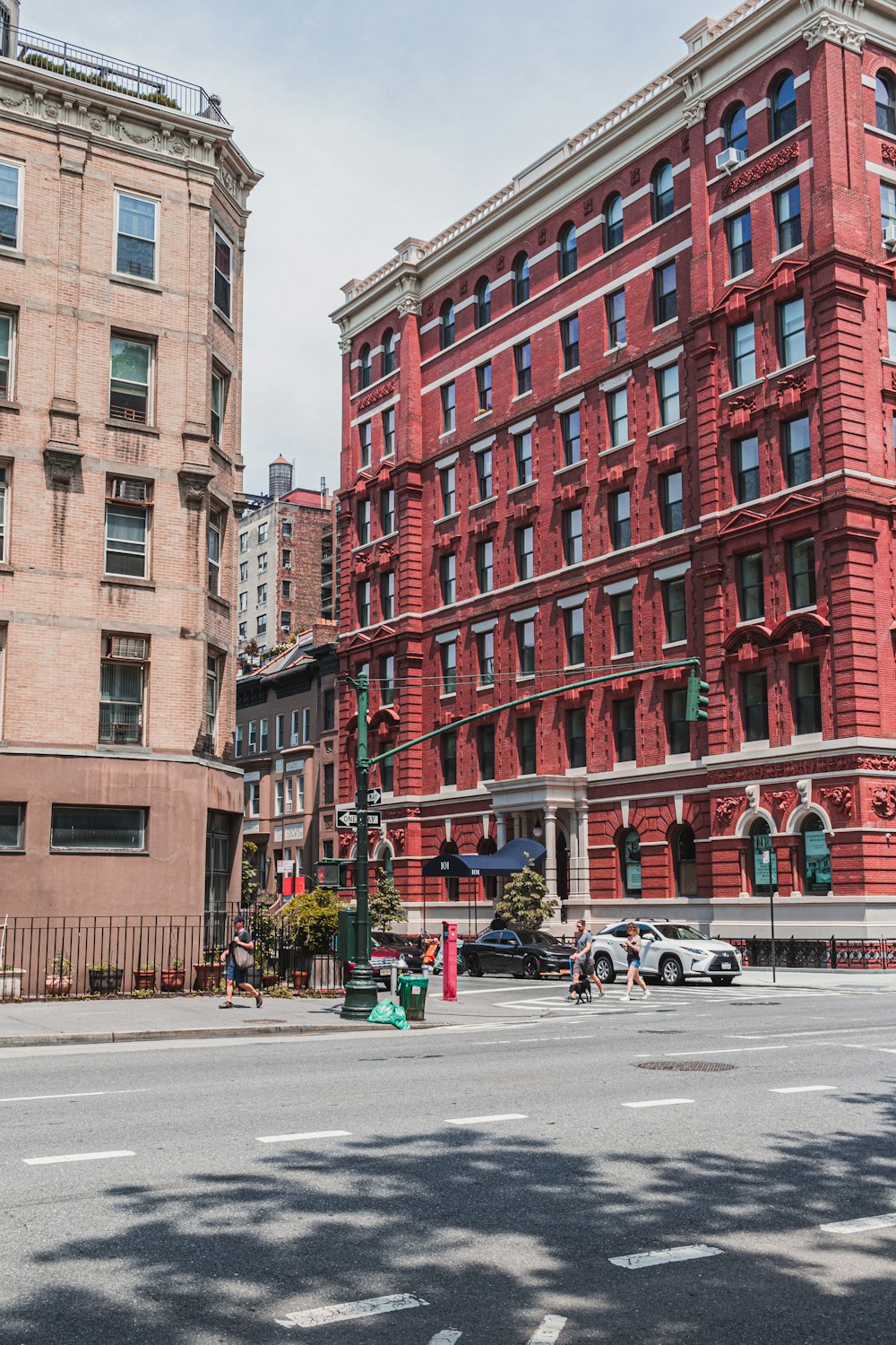 cars parked beside red concrete building during daytime