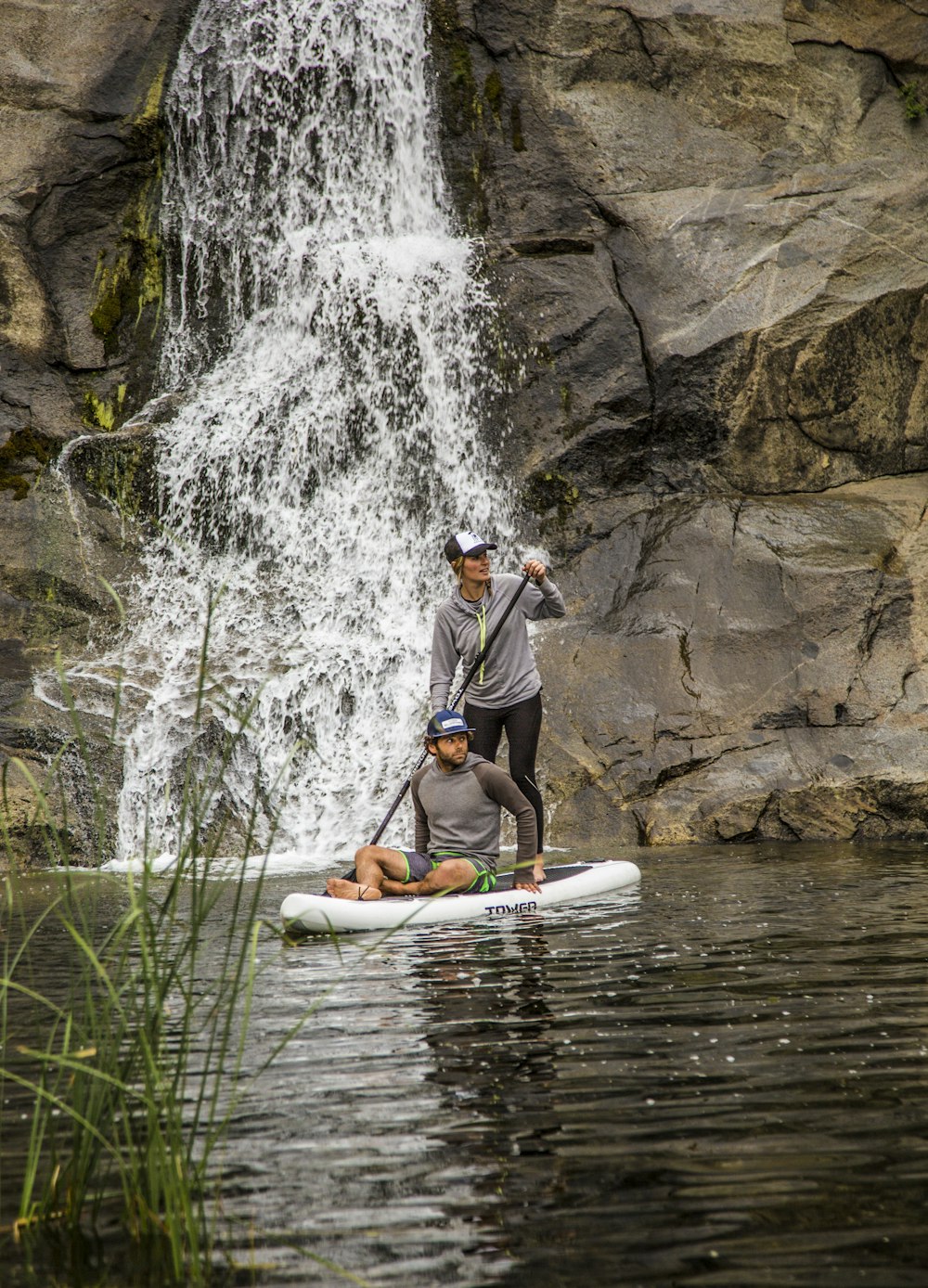 man in gray shirt and blue shorts riding yellow kayak on river during daytime