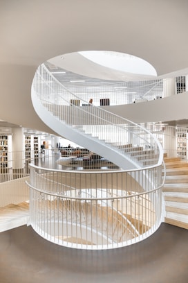 white spiral staircase with stainless steel railings