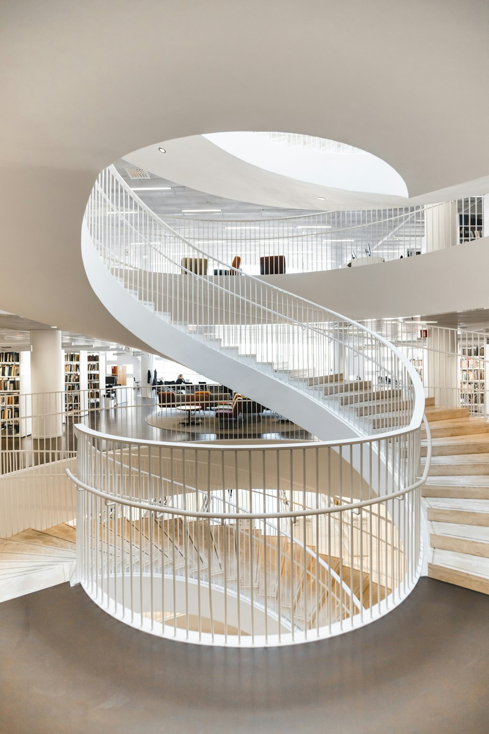 white spiral staircase with stainless steel railings