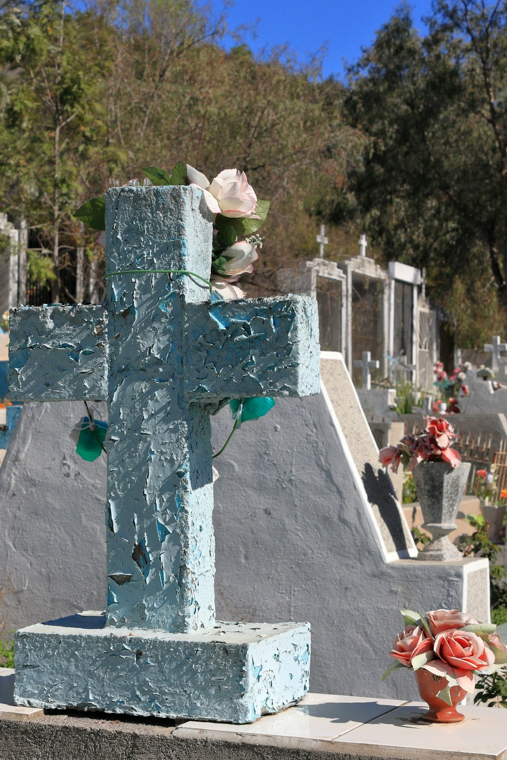 a cross with a flower on top of it