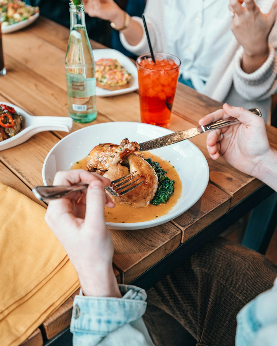 person holding stainless steel fork and knife