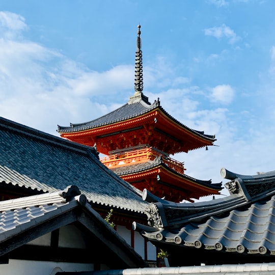 brown and white temple under blue sky during daytime in Kiyomizu-dera Japan
