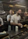A confident chef consulting with a restaurant manager in a busy kitchen.