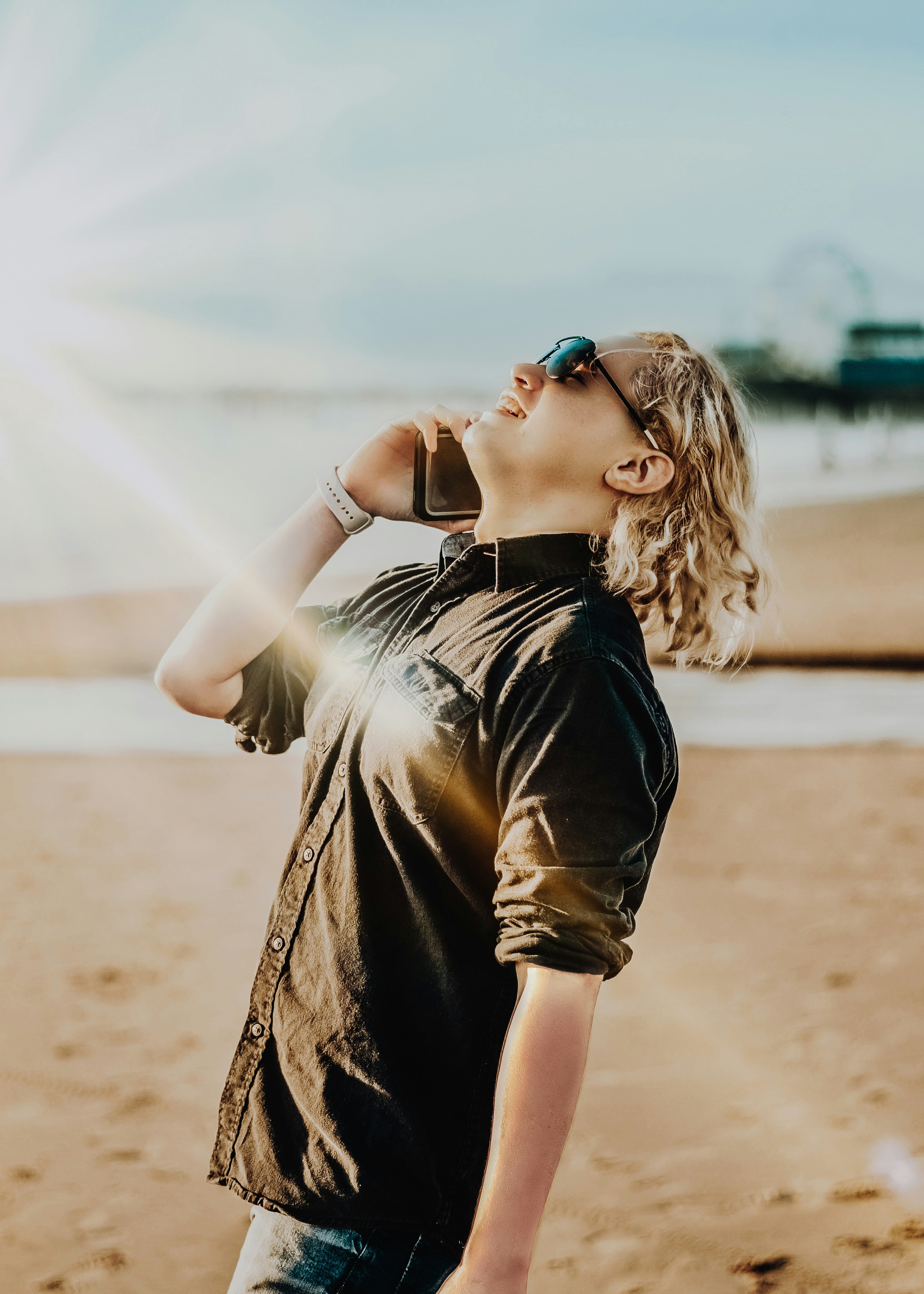 woman in black and brown dress wearing blue sunglasses