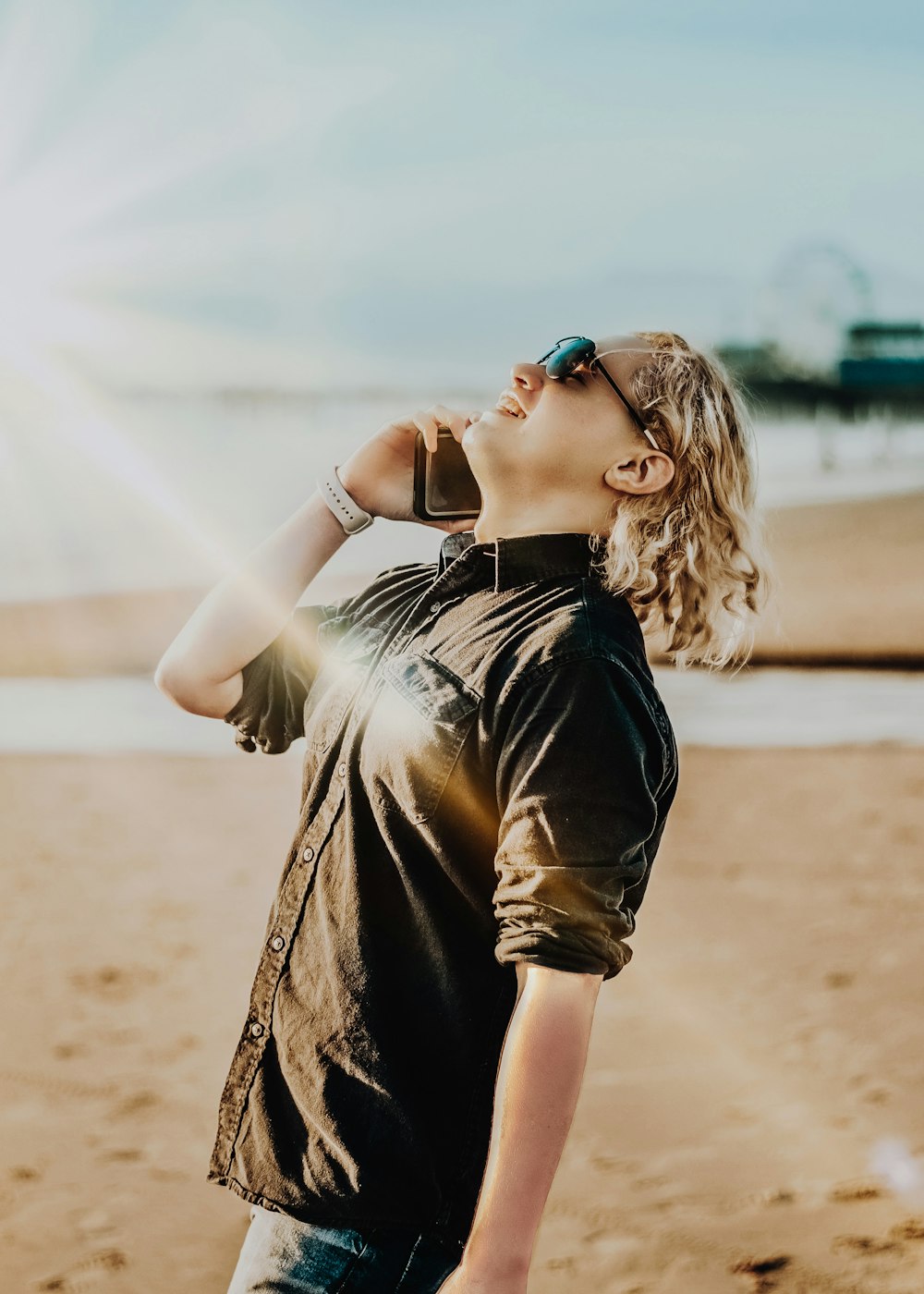 woman in black and brown dress wearing blue sunglasses