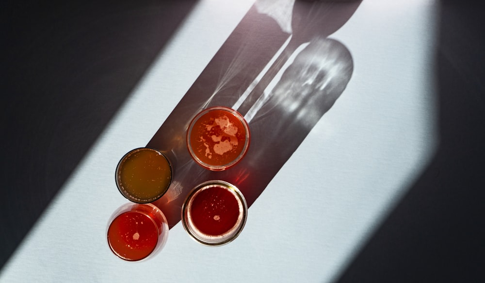 stainless steel fork beside orange liquid in drinking glass