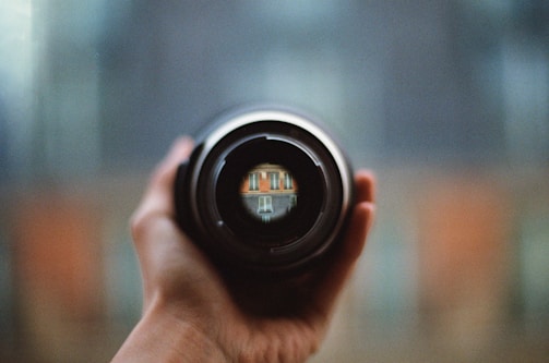 Close-up of a high-resolution camera lens focused on a commercial property.