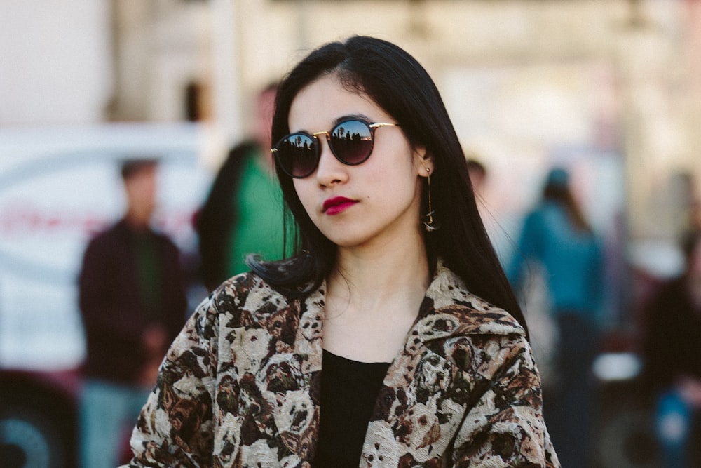 woman in black and white floral long sleeve shirt wearing black sunglasses