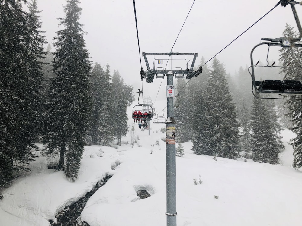 red cable car over snow covered ground