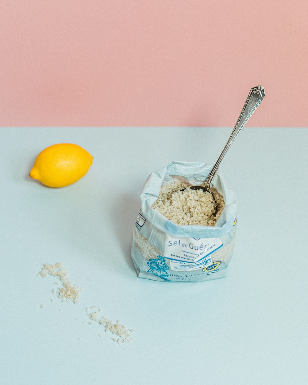 white and blue labeled plastic container with stainless steel spoon