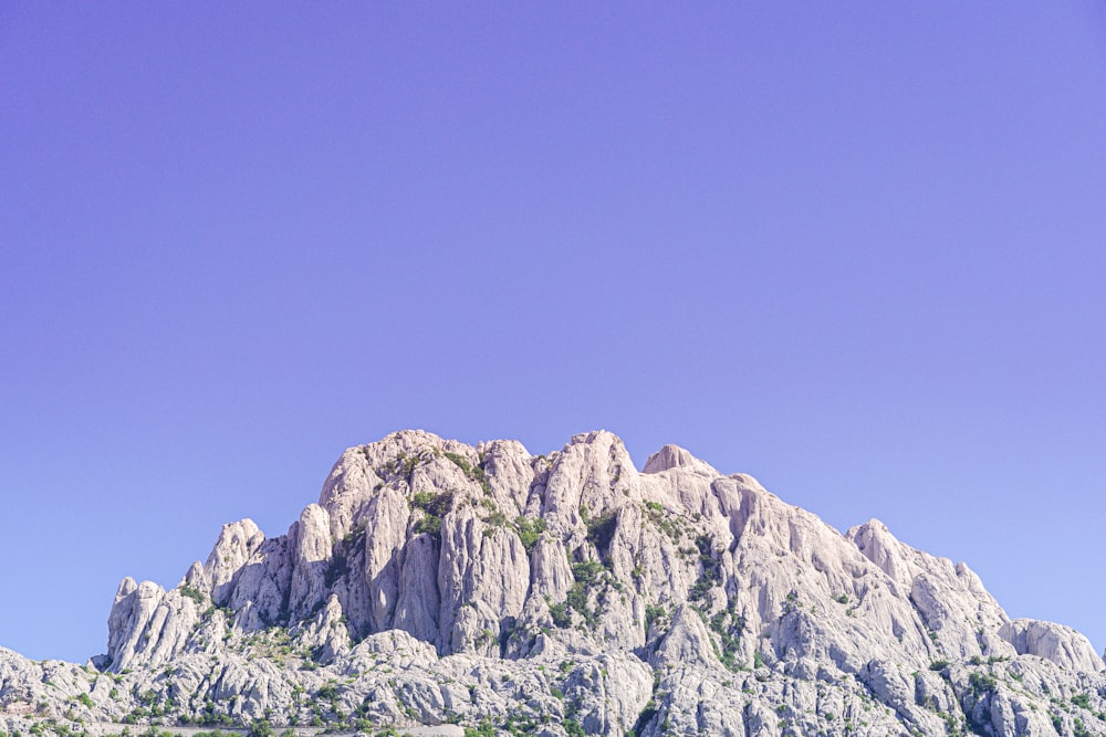 gray rocky mountain under blue sky during daytime