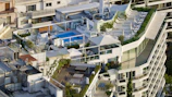 Rooftop terrace with greenery and seating area in a San Isidro apartment complex