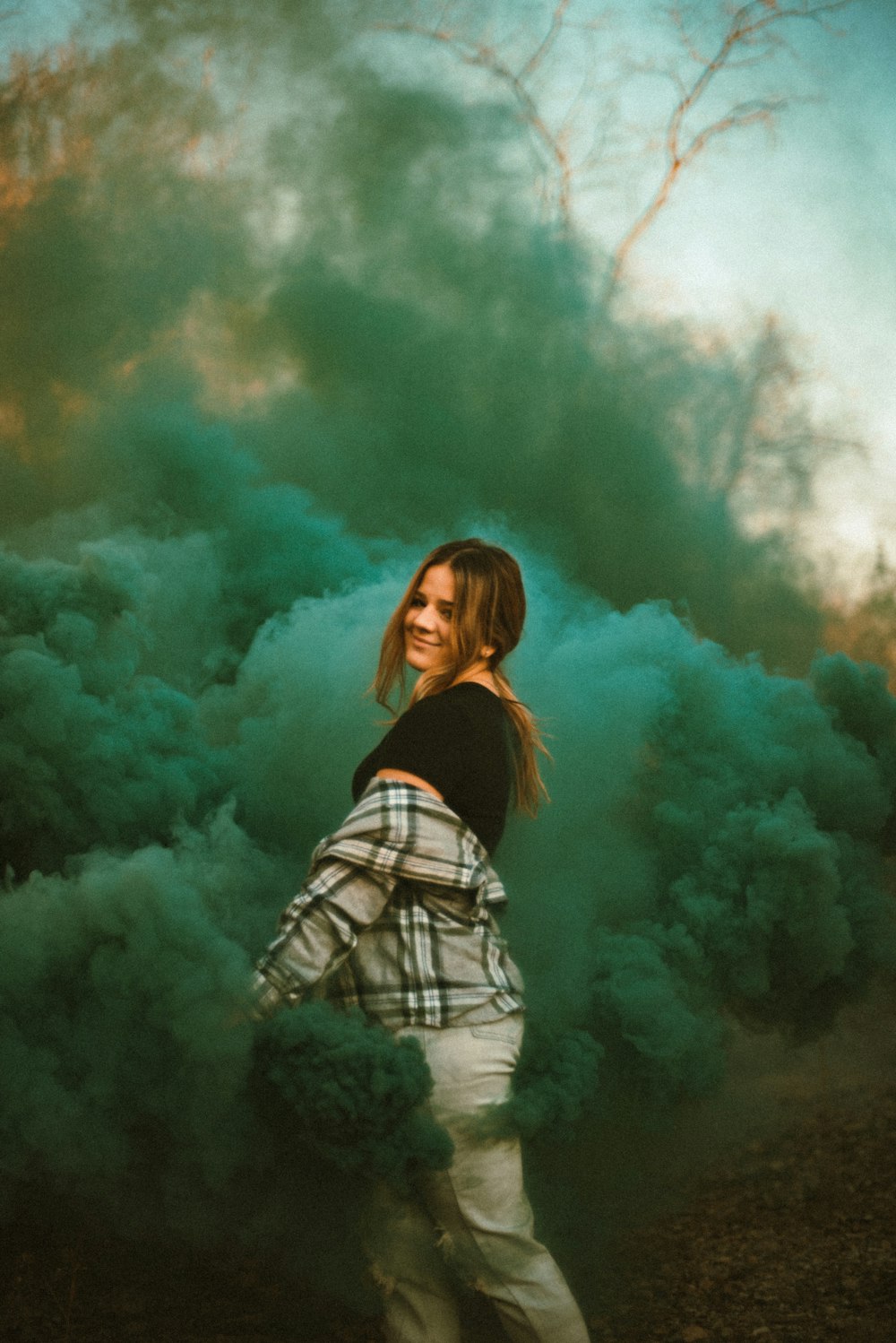 woman in black and white striped long sleeve shirt standing under white clouds