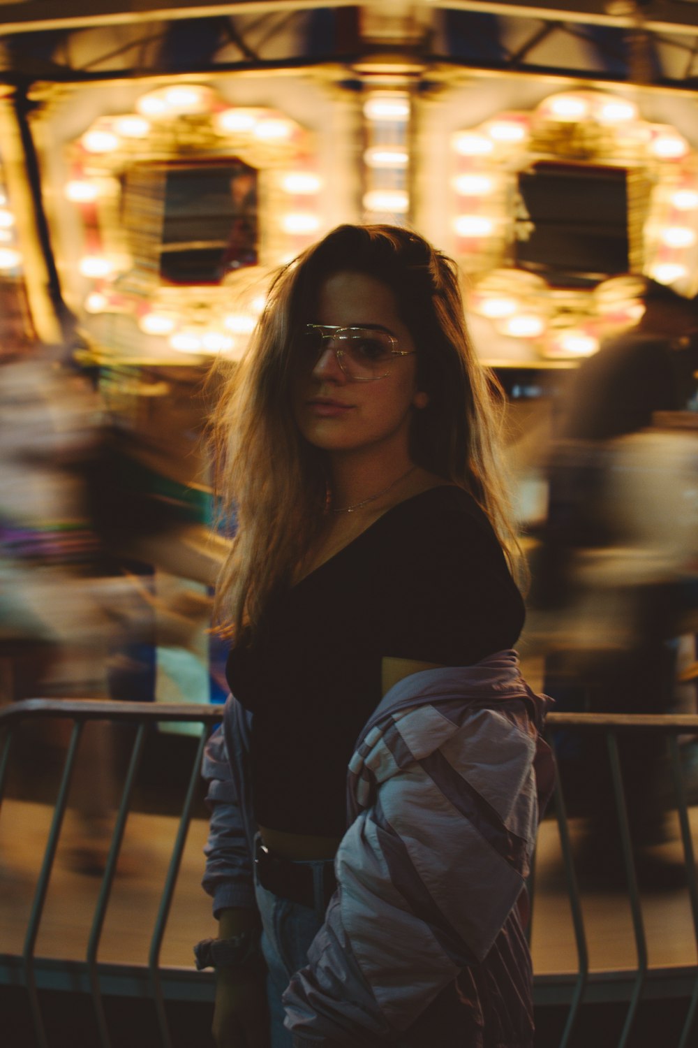 woman in black shirt and white and gray plaid skirt wearing black sunglasses