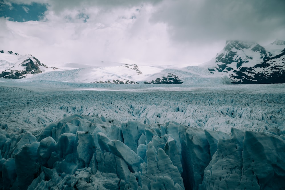 snow covered mountain under cloudy sky during daytime