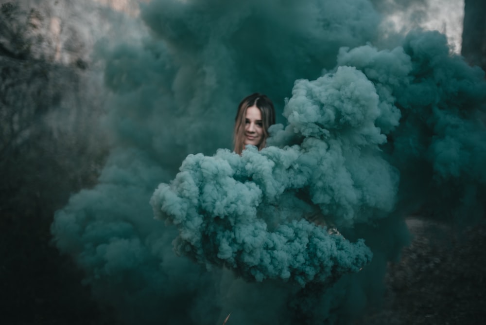 woman in white fur coat standing in front of white smoke