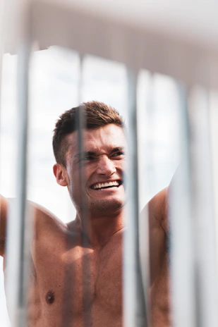 Smiling man showing his before and after photos holding the e-book.