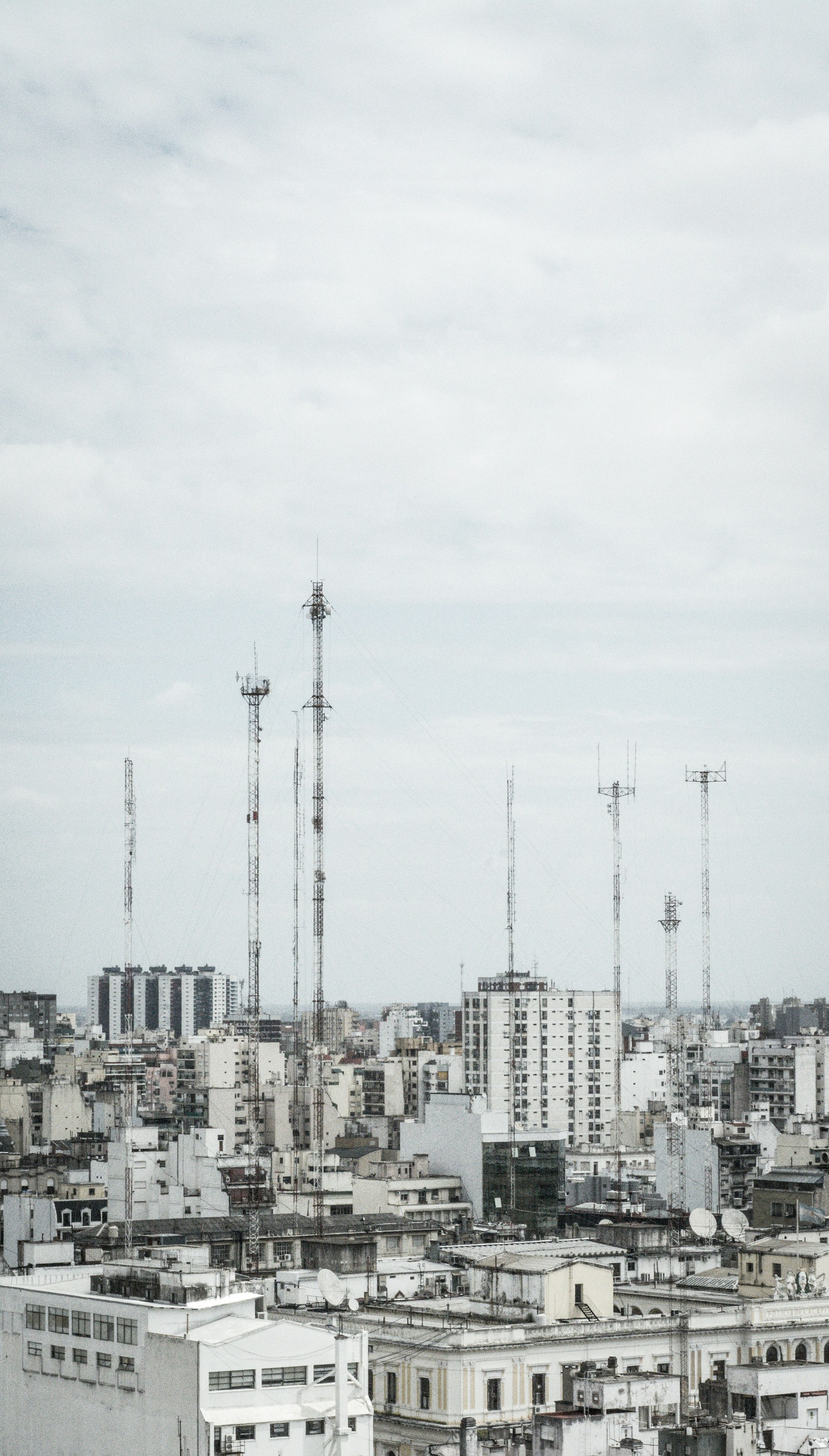 white and gray concrete buildings under white sky during daytime
