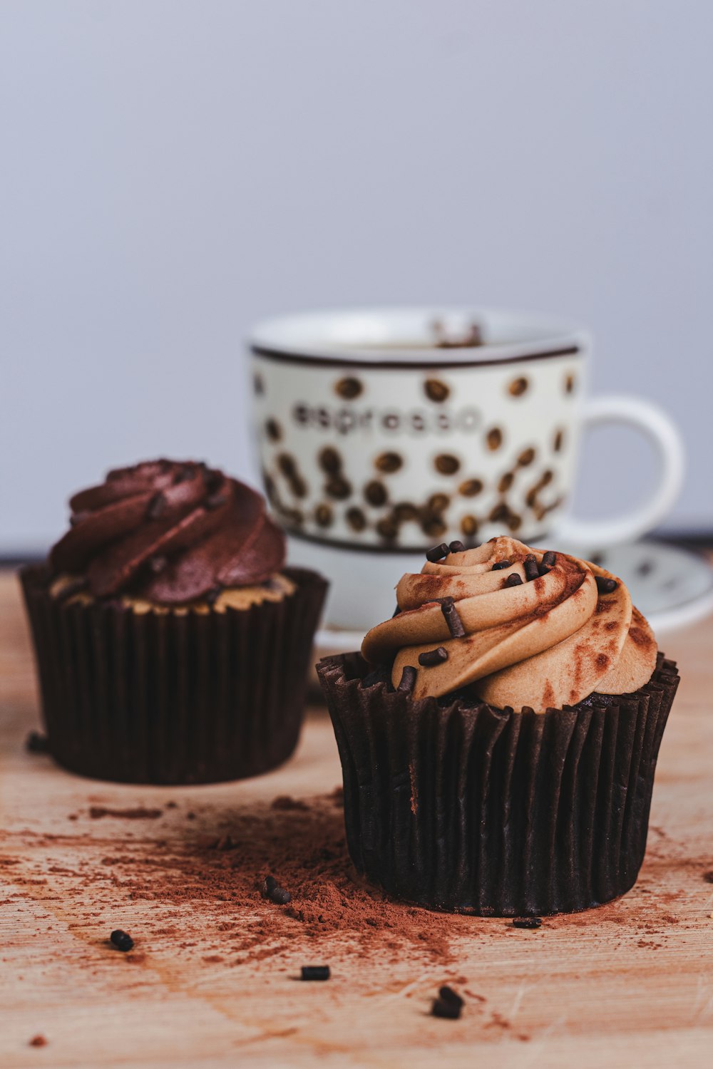 white and black polka dot ceramic mug beside brown cookies