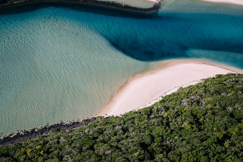 an aerial view of a body of water near a beach