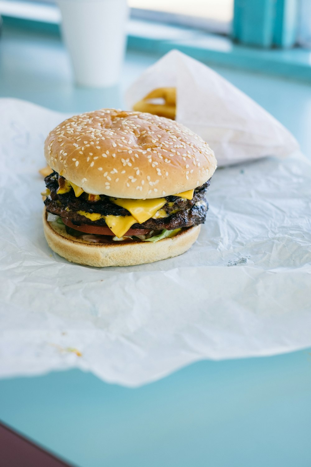 burger on white paper on white textile