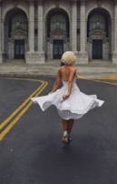 A model twirling in a flowing dress on a city street, capturing movement and joy.