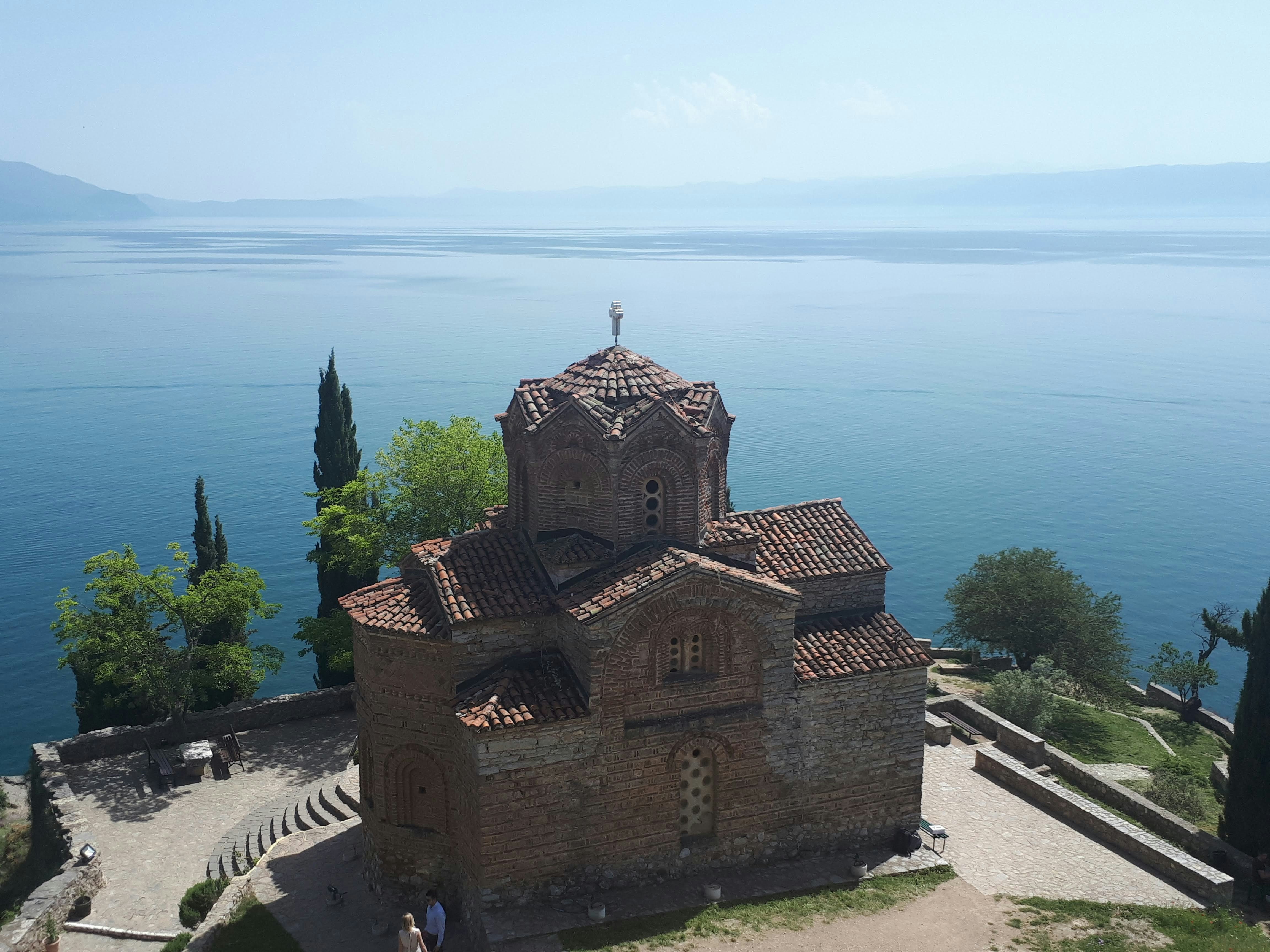 brown concrete building near body of water during daytime