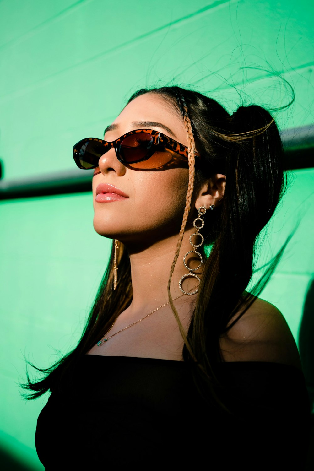 woman in black tank top wearing gold framed aviator sunglasses