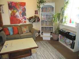 A warm, colorful living room in a children’s home filled with playful decorations and cozy furniture.