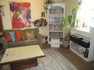 A warm, colorful living room in a children’s home filled with playful decorations and cozy furniture.