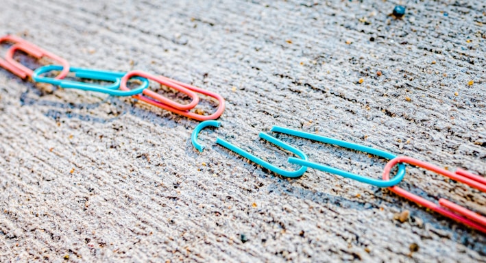 blue green and red plastic clothes pin