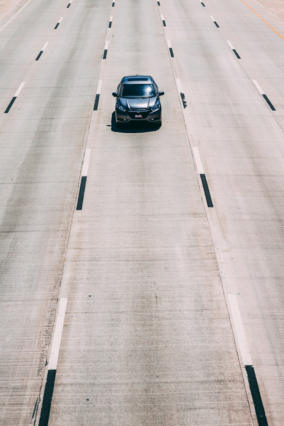 black car on gray asphalt road