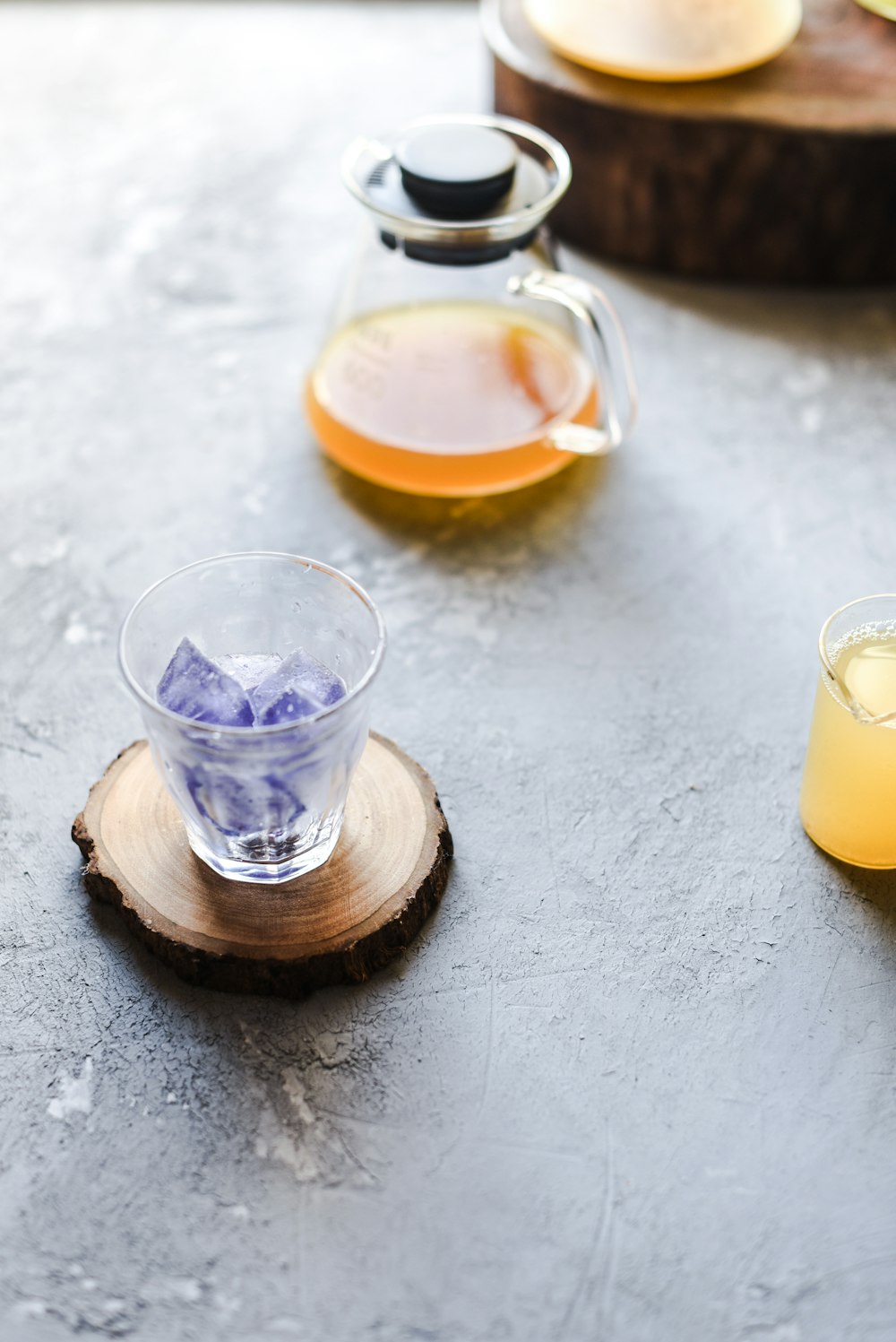 clear drinking glass with yellow liquid inside