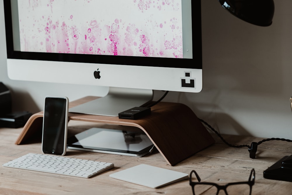 silver imac on brown wooden table