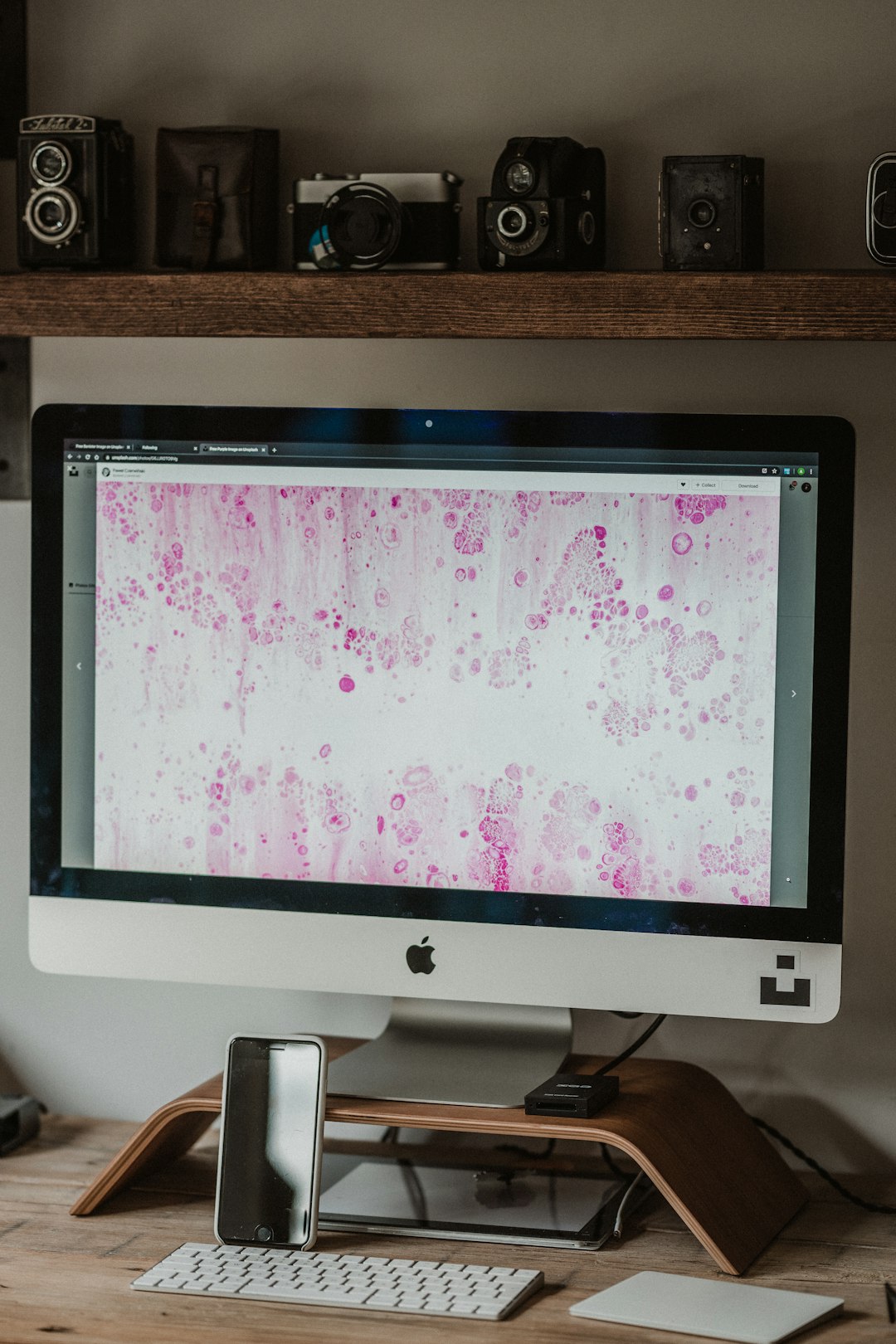 silver imac on brown wooden table