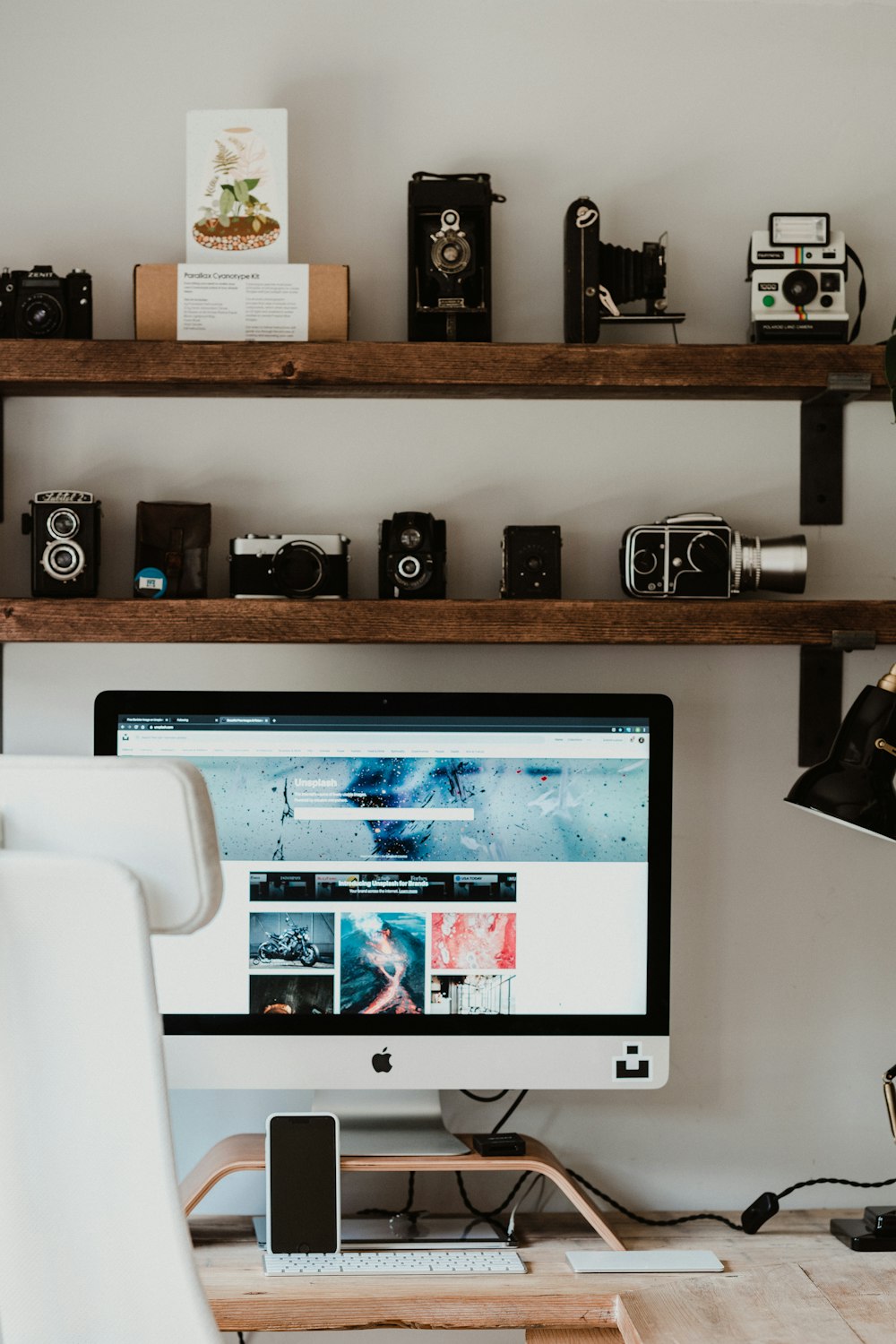 black flat screen computer monitor on brown wooden desk