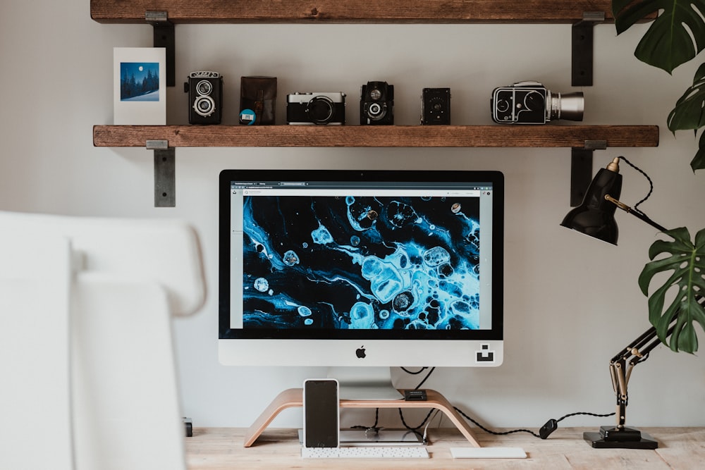 silver imac on brown wooden table