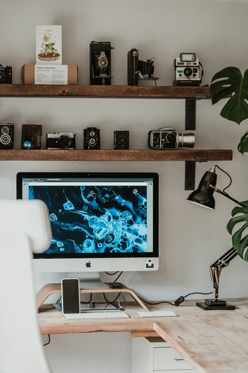 silver imac on brown wooden table