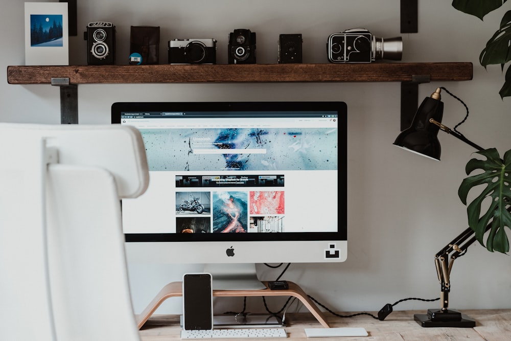 silver imac on brown wooden table