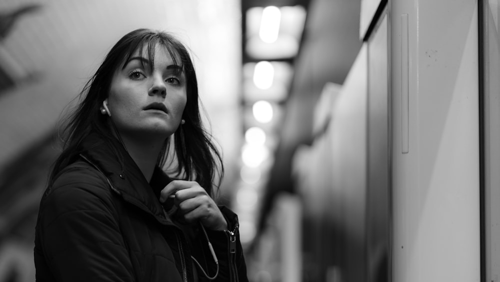 grayscale photo of woman in black jacket