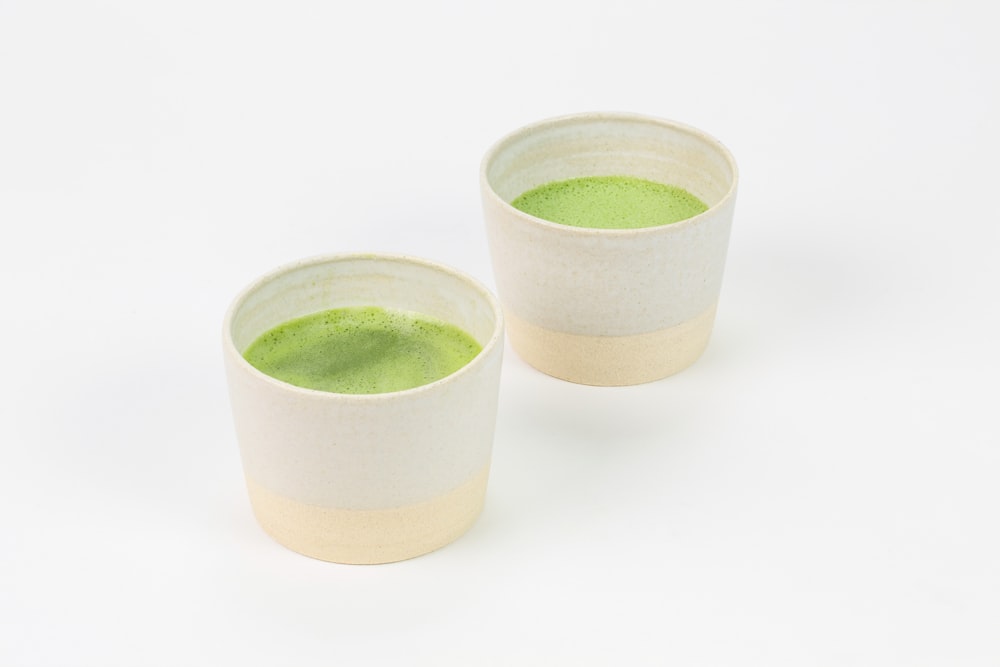 3 green ceramic cups on white surface