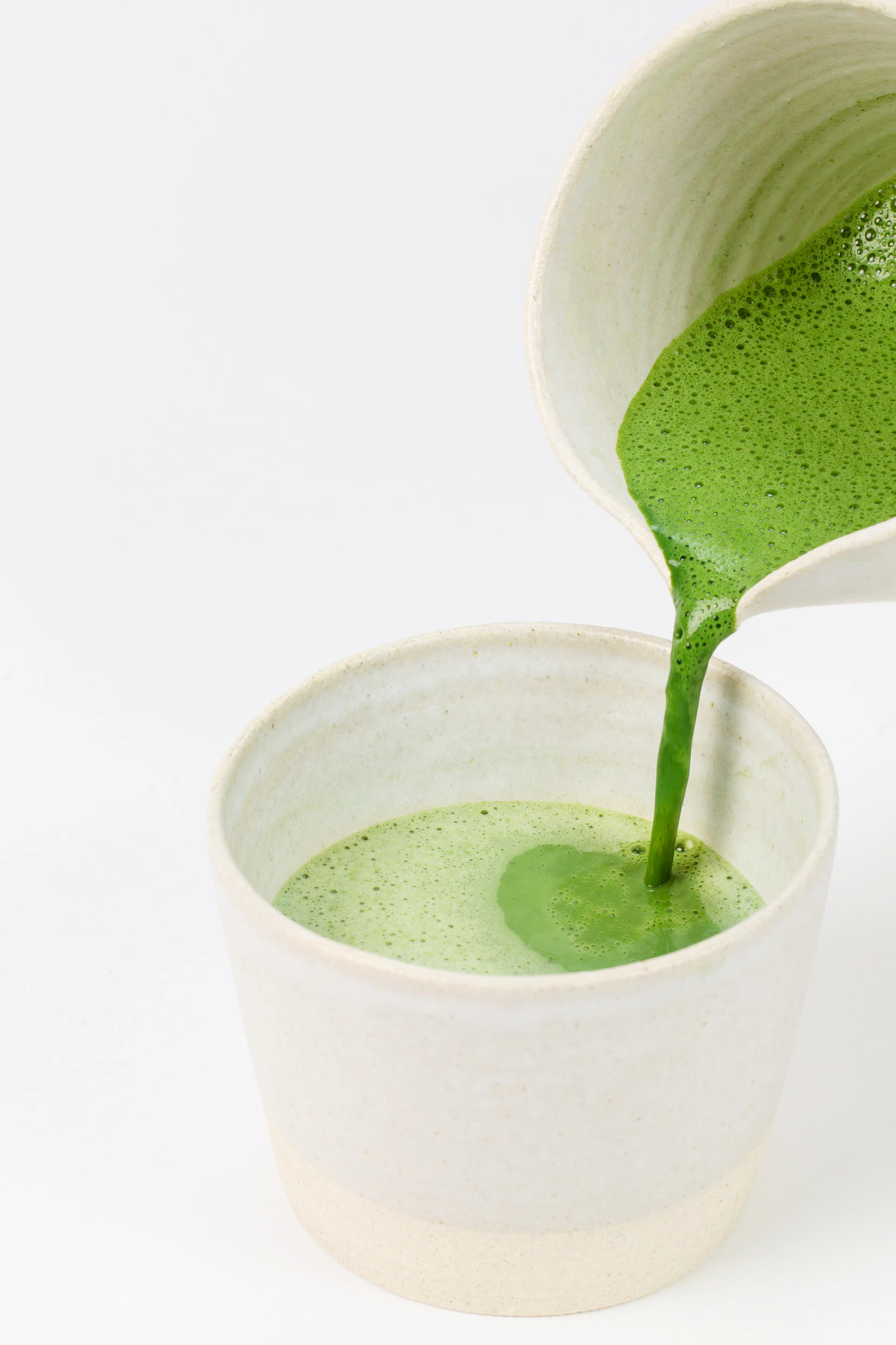 green liquid in white ceramic cup