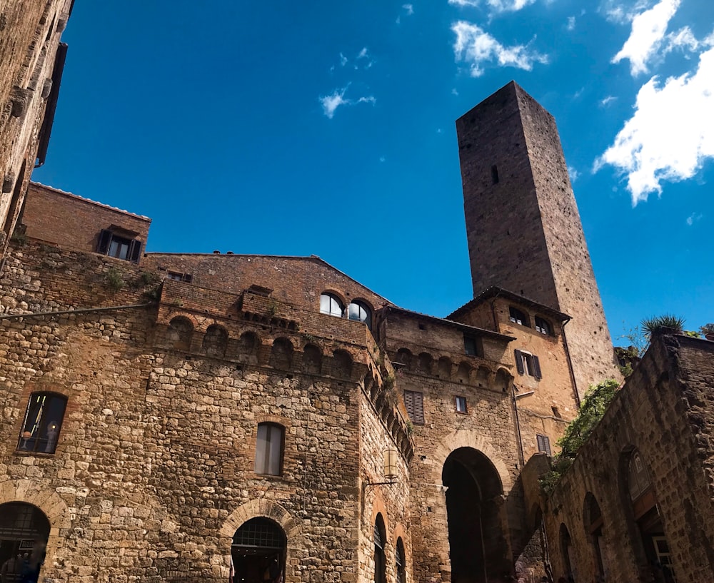 edificio in mattoni marroni sotto il cielo blu