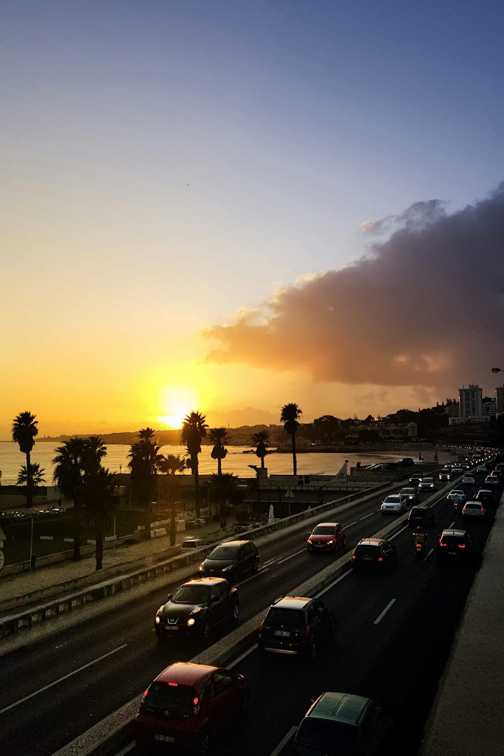 cars on road during sunset