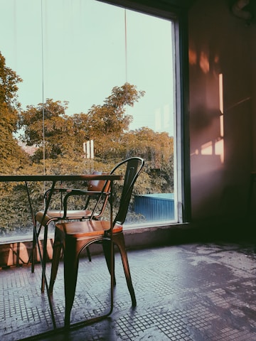 A serene urban apartment corner featuring an urbanease massage chair bathed in natural light.