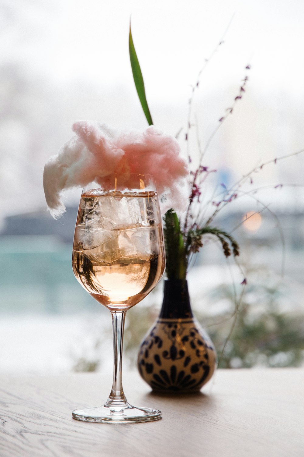 pink flower in clear glass bottle