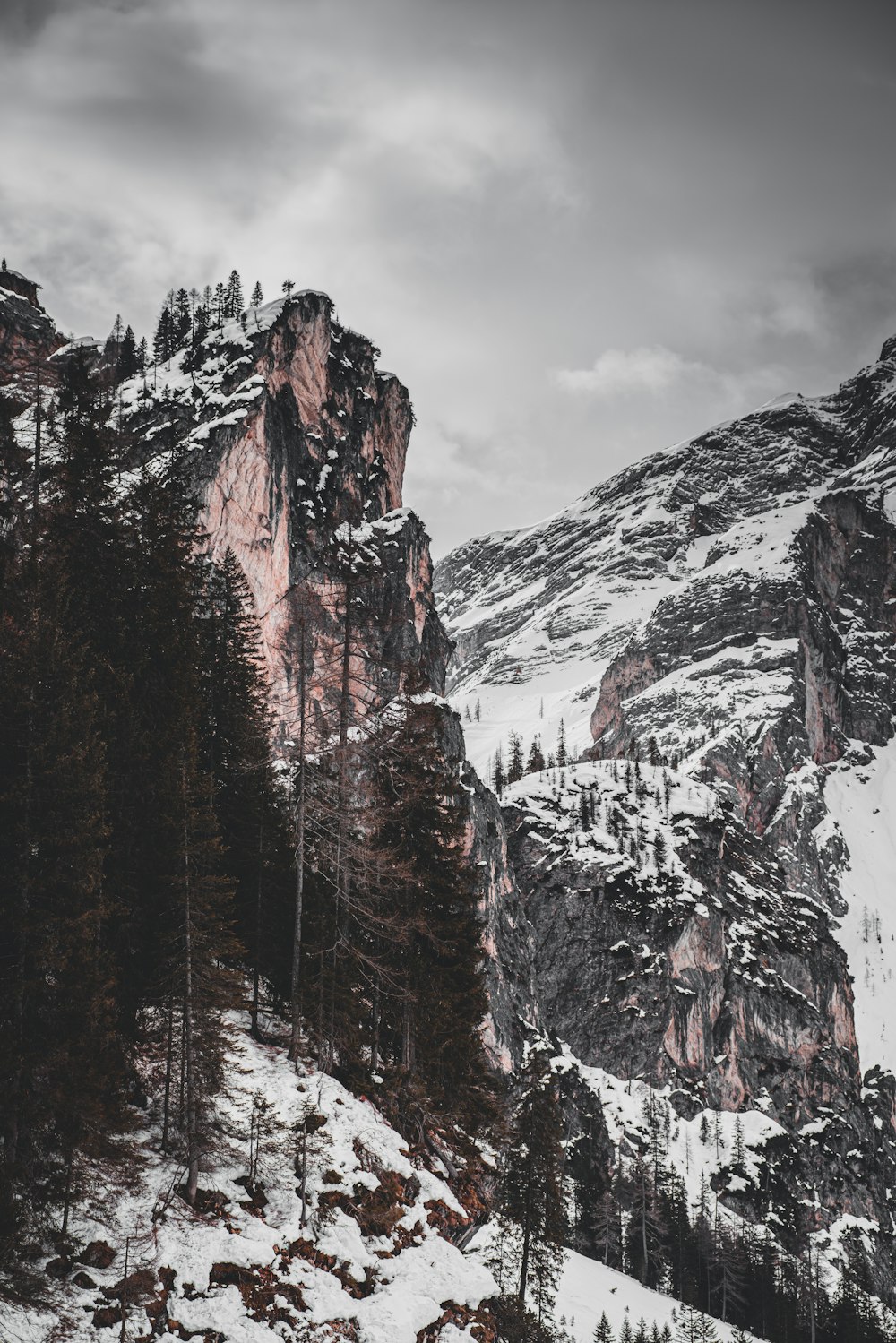 brown and white mountain under cloudy sky during daytime