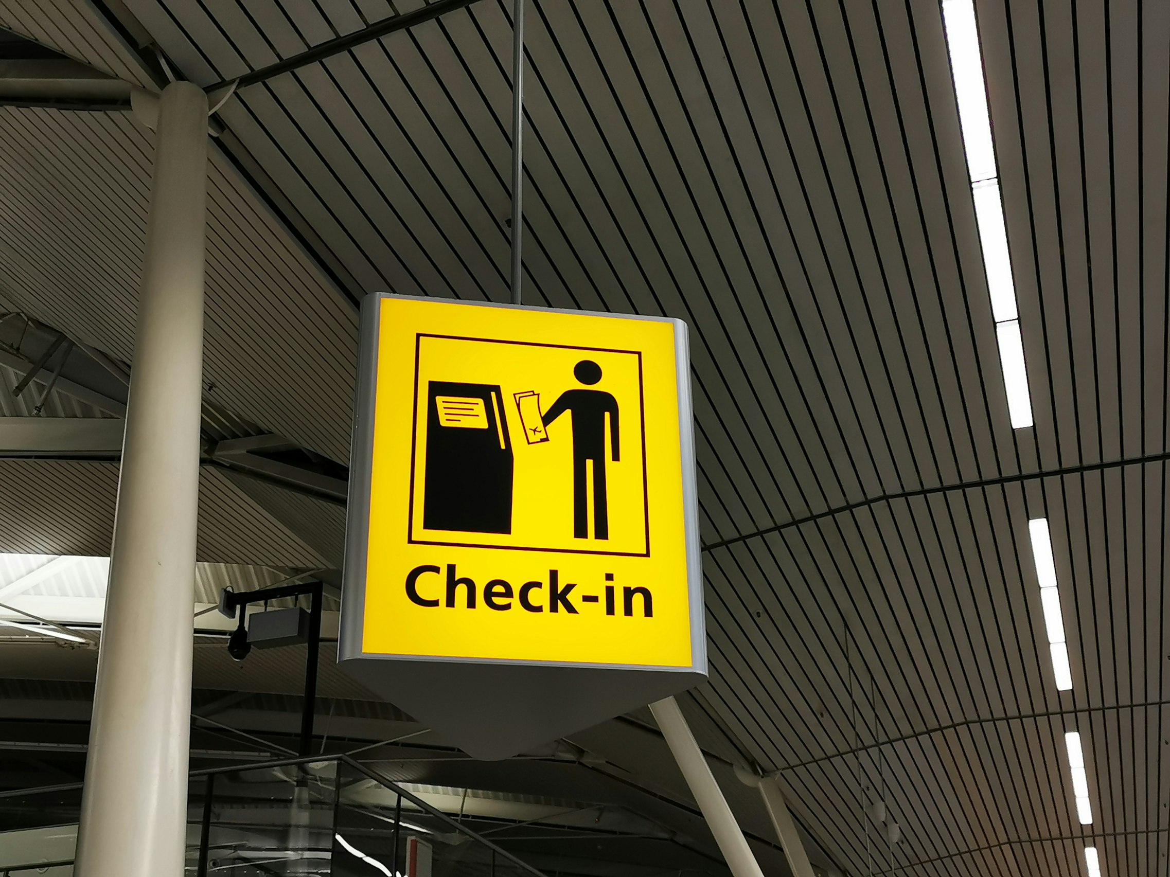 Unsplash image from Larissa Gies showing a yellow check-in sign