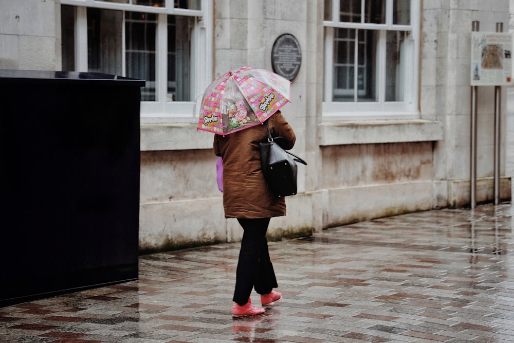 woman in black jacket holding umbrella